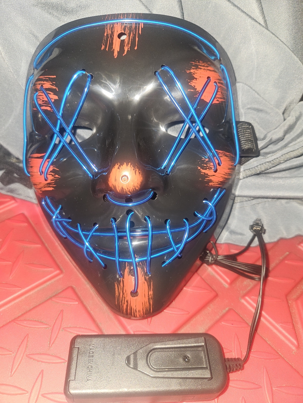 LED Evil Smile Mask in Black with Blue and Orange Accents